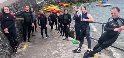 Medical colleagues in wetsuits after kayaking
